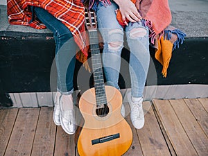 Unrecognizable girls have rest with guitar