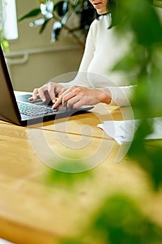 Unrecognizable hand Woman using, search a laptop at home