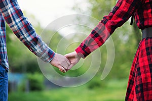 Unrecognizable hands couple in nature