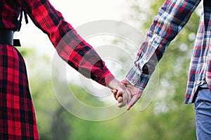 Unrecognizable hands couple in nature