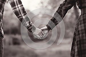 Unrecognizable hands couple in nature