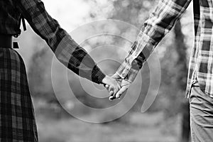 Unrecognizable hands couple in nature