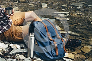 Unrecognizable hiker man drink tea or coffee from thermos Hiking Resting Concept