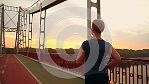 Unrecognizable jogger female run on the bridge