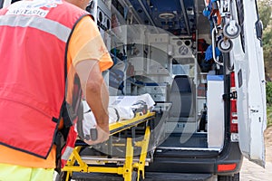 Unrecognizable Lifeguard worker working on an ambulance