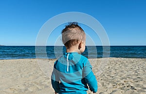 unrecognizable little boy on the beach.