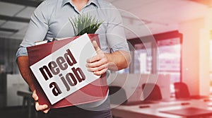 Unrecognizable Male Office Worker Holding A Box With Inscription Need A Job. Unemployment Concept