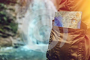 Unrecognizable Male Traveler Standing With Travel Map In Pocket Closeup Hiking Travel Tourism Concept