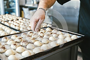 unrecognizable man cooking buns. Traditional Italian cuisine