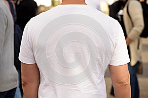 Unrecognizable man dressed white t-shirt. Template for your design. Rear view. Closeup