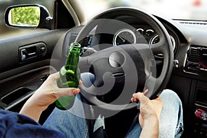 Unrecognizable man drinking and driving. Dangerous driving conce