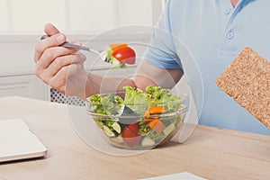 Unrecognizable man has healthy business lunch in modern office interior