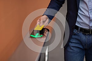 Unrecognizable man holding electronic entrance gate card, closeup