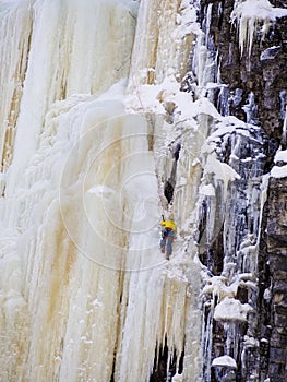 A Unrecognizable man ice climbing at Finland