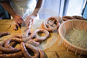 Unrecognizable man making sausages the traditional way at home.