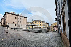 Unrecognizable man with an open umbrella in La Plaza del Paraguas which is a beautiful space located in the historic photo