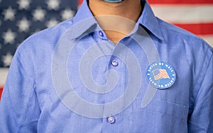 Unrecognizable Man Pasted I voted by mail sticker on his sticker with US flag as background - Concept of US election