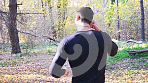 Unrecognizable man running along forest path. Male sportsman working out at nature. Strong and endurance athlete doing