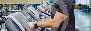 Unrecognizable man setting control panel of treadmill for training