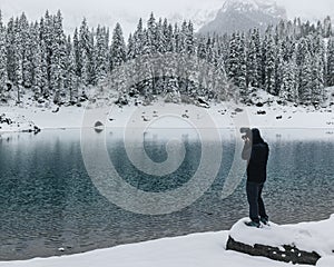 Unrecognizable man standing on a rock taking pictures
