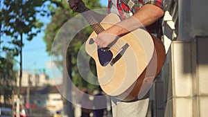 Unrecognizable man street guitarist in shirt, Sunny