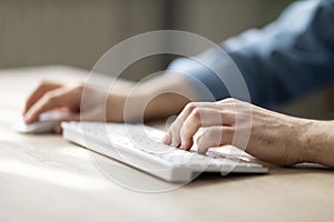Unrecognizable Man Typing On Computer Keyboard And Using Wireless Mouse