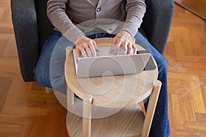 Unrecognizable man typing on laptop