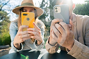 Unrecognizable man and woman looking at a cell phone. Technology addicts