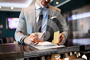 Mature businessman at hotel reception.