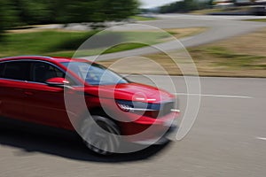 Unrecognizable modern car, auto and automobile. Strong motion blur as expression of speed and fast and dynamic movement of vehicle