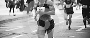 Unrecognizable muscular runner outdoors. Long distance running. Black and white