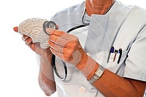 unrecognizable nurse with a stethoscope on a plastic brain. Mental health. neuroscience
