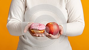 Unrecognizable Obese Woman Holding Donut And Apple In Hands