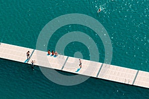 Unrecognizable people enjoying summer afternoon on lake