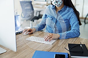 Unrecognizable person in face mask working in the office