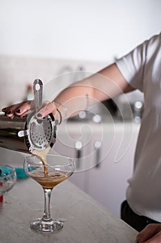 An unrecognizable person making cocktails at home