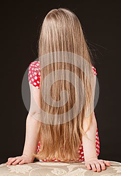 Unrecognizable portrait of a little girl with beautiful long hair