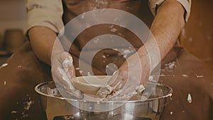 Unrecognizable Potter Shaping Clay Making Plate Using Pottery-Wheel Indoor, Closeup