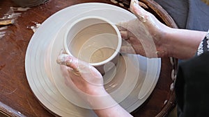 unrecognizable pottery woman working with pottery wheel