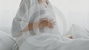 Unrecognizable Pregnant Lady Touching Belly While Sitting In Bed, Suffering Prenatal Contractions