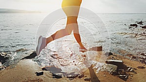 Unrecognizable Sporty Girl Runs along The Beach. Concept Of Biohacking, Sports And Fitness