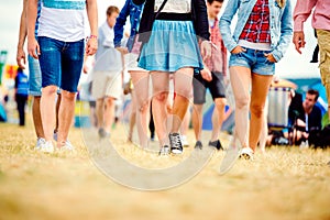 Unrecognizable teenagers, tent music festival, sunny summer, leg