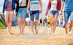 Unrecognizable teenagers, tent music festival, sunny summer, leg