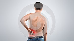 Unrecognizable topless man touching his lower back