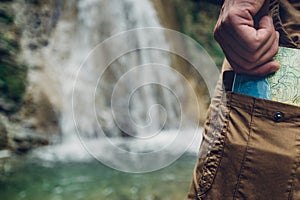 Unrecognizable Tourist Man Puts Map In Pocket Of Pants Hiking Travel Tourism Concept