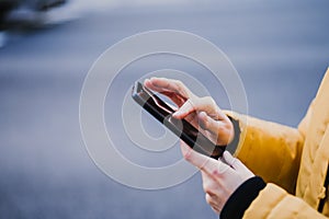 unrecognizable tourist woman using mobile phone outdoors in the street. lifestyle and travel concept