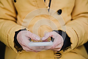 unrecognizable tourist woman using mobile phone outdoors in the street. lifestyle and travel concept