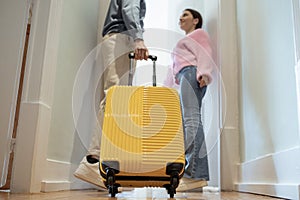 Unrecognizable Tourists Couple Entering Hotel Room, Selective Focus On Suitcase