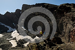 Unrecognizable tourists standing on rock