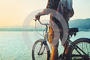 Unrecognizable Traveler Man Standing With Bike On Coast And Enjoying View of Nature Sunset Vacation Traveling Relaxation Resting C